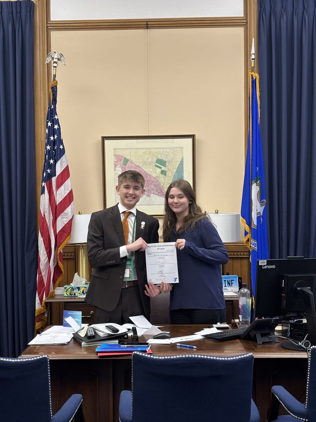 Two students holding a signed bill