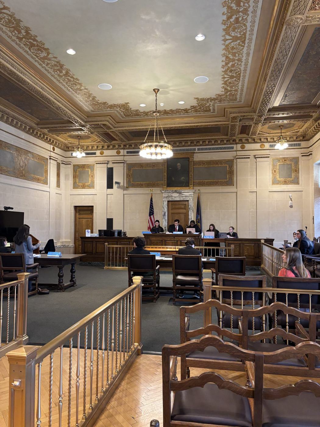 Student justices hearing a case in a New York courtroom