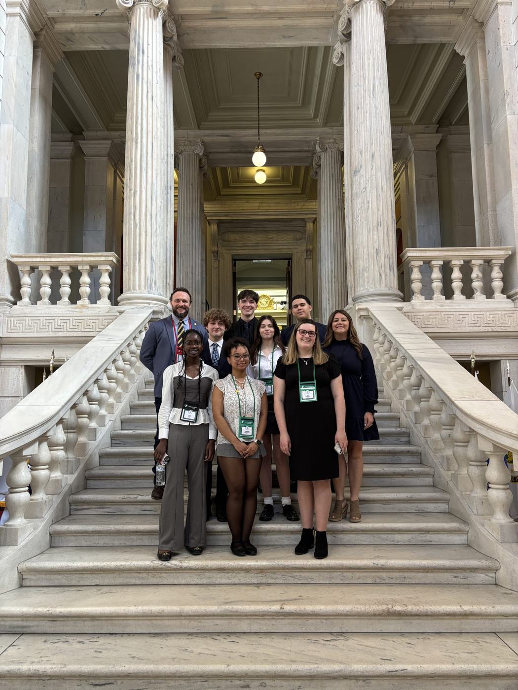 A Rhode Island delegation with advisors on the State House staircase