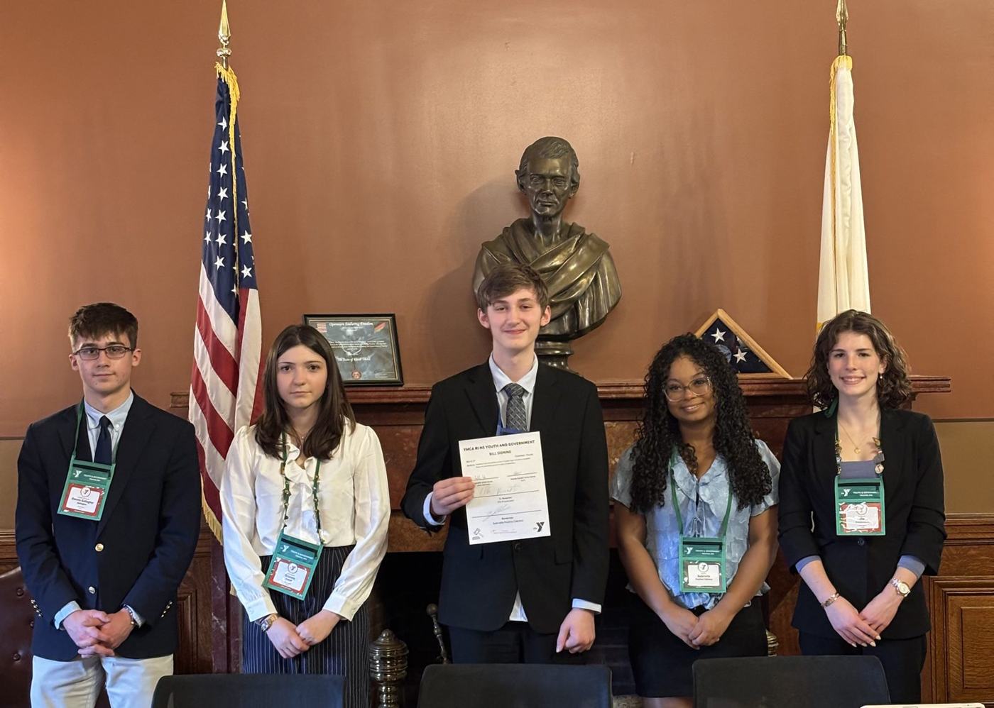 Rhode Island students with a signed bill in a State House committee room